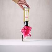 Refilling a pink Angel Nova star perfume bottle with a yellow refill bottle held upside down