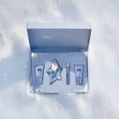 An open, textured ice-blue glistening Mugler gift set resting on snow, revealing an angel eau de parfum 50ml luxury gift set