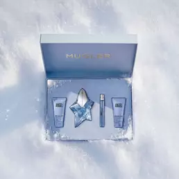 An open, textured ice-blue glistening Mugler gift set resting on snow, revealing an angel eau de parfum 50ml luxury gift set