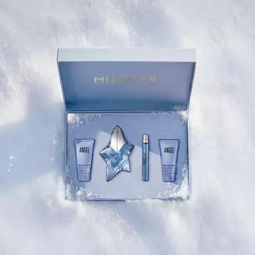 An open, textured ice-blue glistening Mugler gift set resting on snow, revealing an angel eau de parfum 50ml luxury gift set