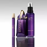 Mugler Alien perfume bottle with refill bottle and travel spray on reflective surface