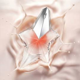 Mugler Angel Blush Eau de Parfum star bottle in a soft nude tone, resting on flowing pink and white silk. 