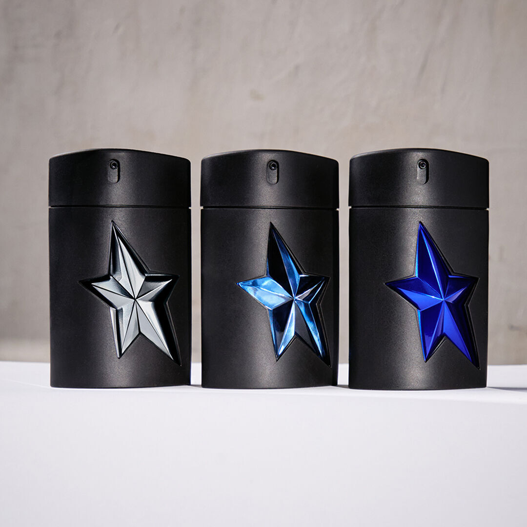 Three black A*Men Mugler bottles with silver and blue star designs