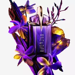 Mugler Alien perfume bottle surrounded by purple flowers and textured wood