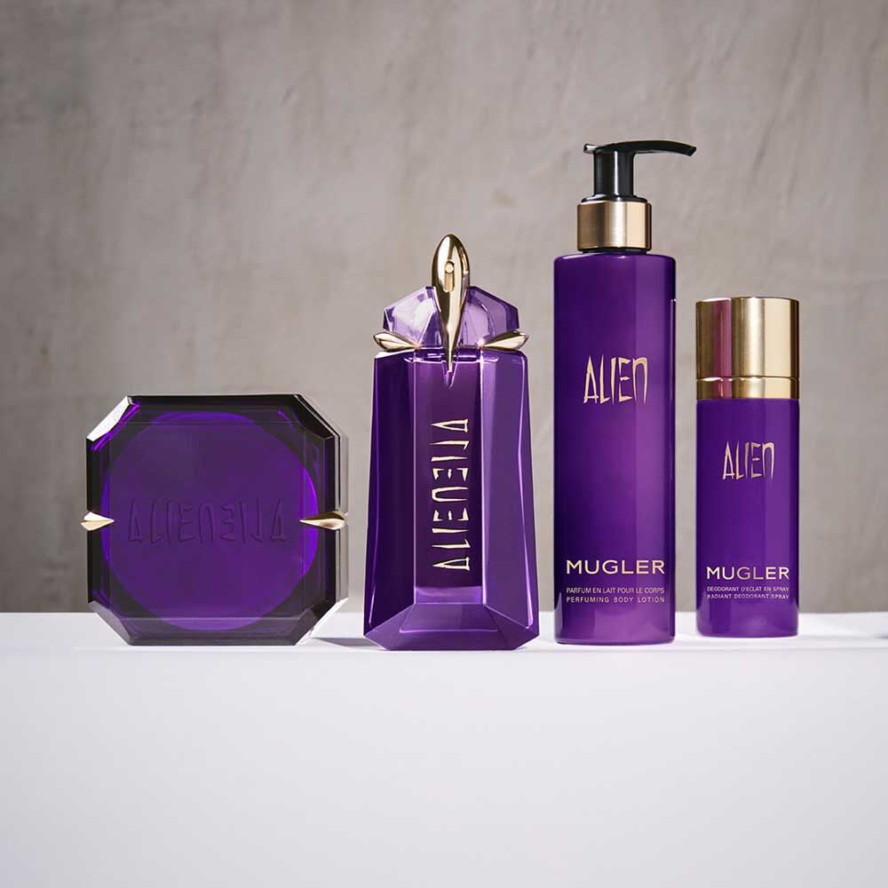 Mugler Alien fragrance and body products arranged on white surface