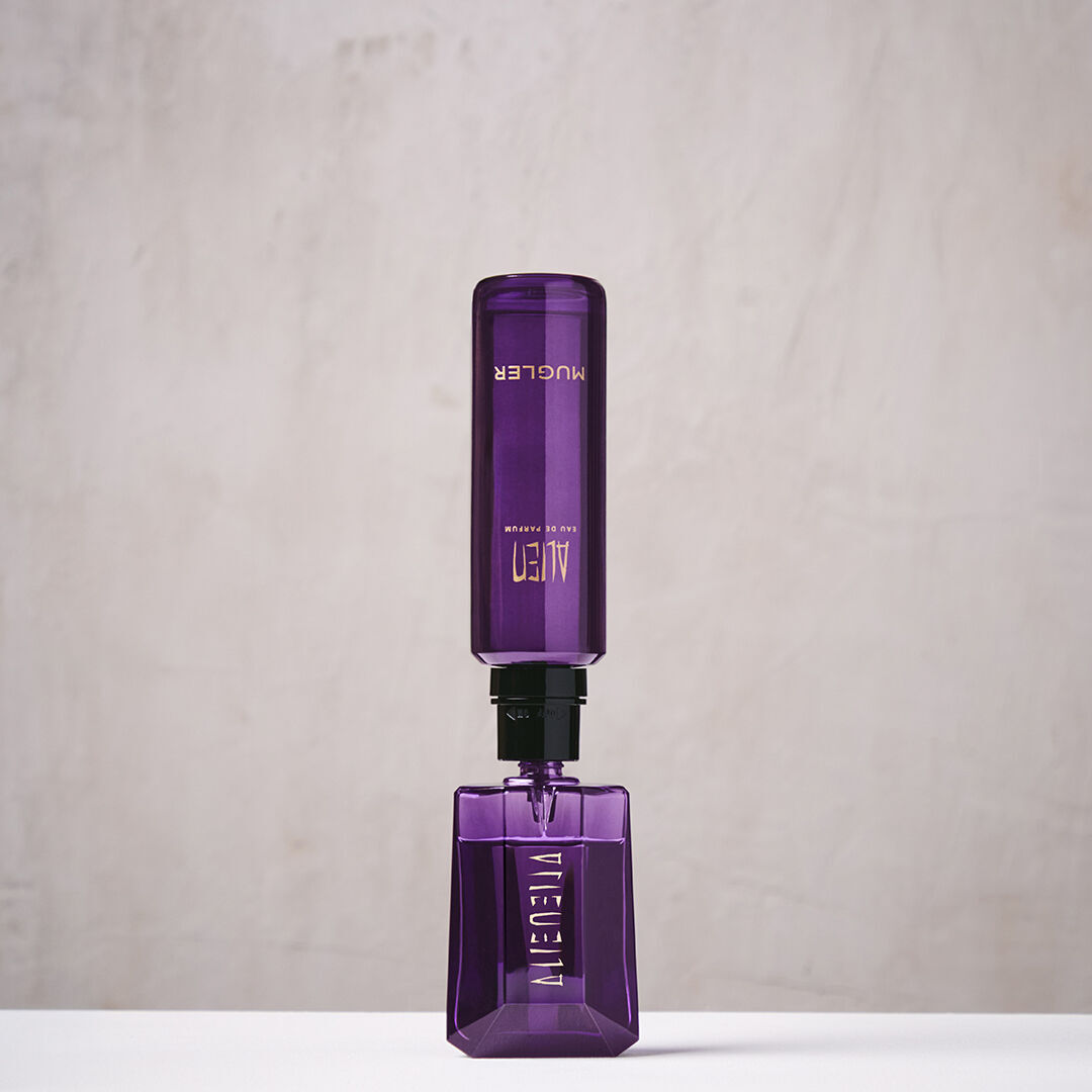 Purple Mugler Alien refill bottle connected upside down to matching perfume bottle