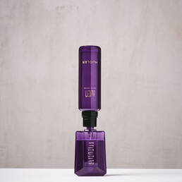 Purple Mugler Alien refill bottle connected upside down to matching perfume bottle