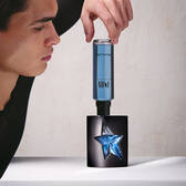 Hand refilling black A*Men Mugler bottle with blue refill bottle