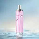Starlicious Berry Licorice still life: slender glass bottle with strawberry, raspberry, pink flower and black licorice sticks on a soft pink rippling water background.