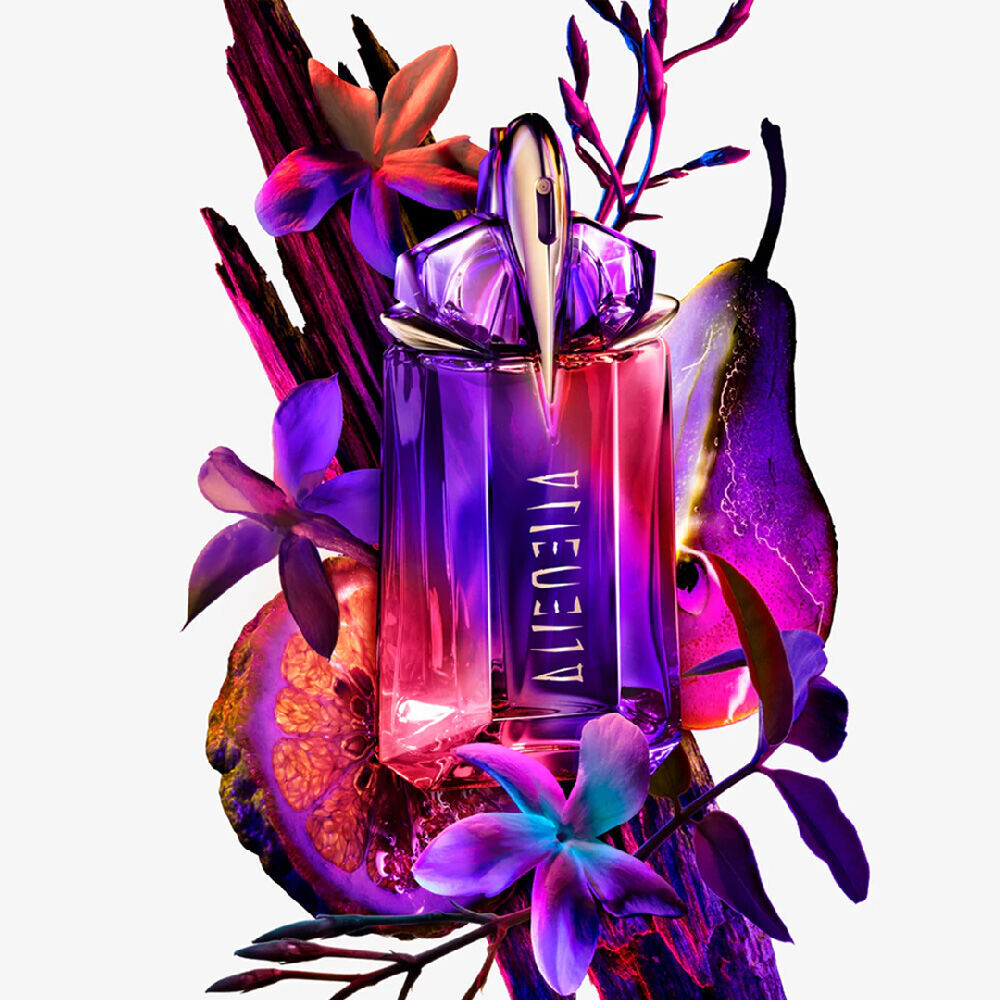 Alien Hypersense bottle surrounded by purple flowers, fruit, and dark wood