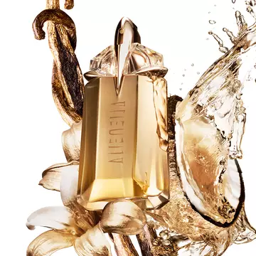 Alien Goddess perfume bottle surrounded by vanilla, flowers, and splashing golden liquid