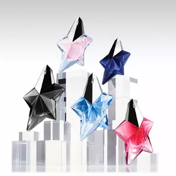 Five Mugler star perfume bottles in black, pink, blue, navy, and red on clear display blocks