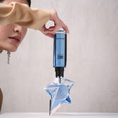 Refilling an Angel Mugler star perfume bottle with a blue refill bottle held upside down​