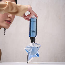 Refilling an Angel Mugler star perfume bottle with a blue refill bottle held upside down​