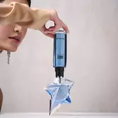 Refilling an Angel Mugler star perfume bottle with a blue refill bottle held upside down​