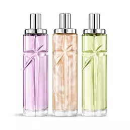 Starlicious the yummy swirl layering bundle packshot with Berry Licorice, Pineapple Musk, and Pistachio Praline, glass bottles with a carved shooting star, its facets shining bright beneath a sleek silver cap.