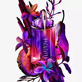 Alien Hypersense bottle surrounded by purple flowers, fruit, and dark wood