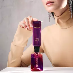 Model refilling Alien bottle from matching purple refill vial