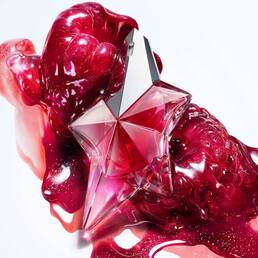 Pink Angel Nova Mugler star perfume bottle with glossy red abstract backdrop