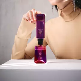 Model refilling Alien bottle from matching purple refill vial