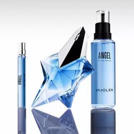 Angel Mugler star bottle with matching blue refill bottle and travel spray on reflective surface