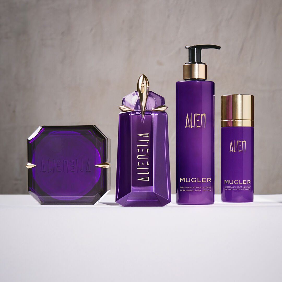 Mugler Alien fragrance and body products arranged on white surface