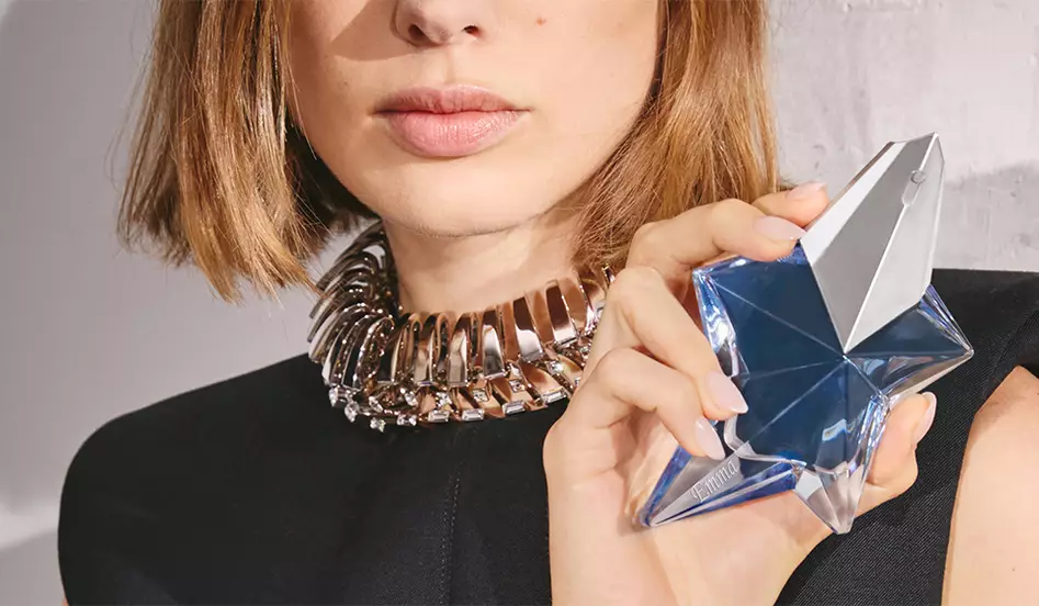 model holding engravable fragrance bottle
