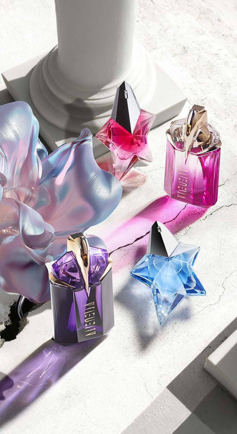 Mugler Mother's Day 2026 campaign banner featuring the iconic Angel and Alien franchise perfume bottles in a celestial floral and Parisian landscape, celebrating extraordinary mothers.