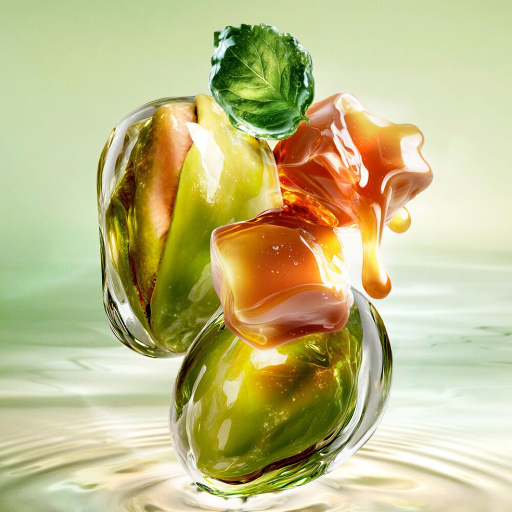 New Starlicious Pistachio Praline ingredient video showcasing its key ingredients: a patchouli leaf, whole pistachios, and dripping caramel cubes, all set against a luminous green rippling water background.