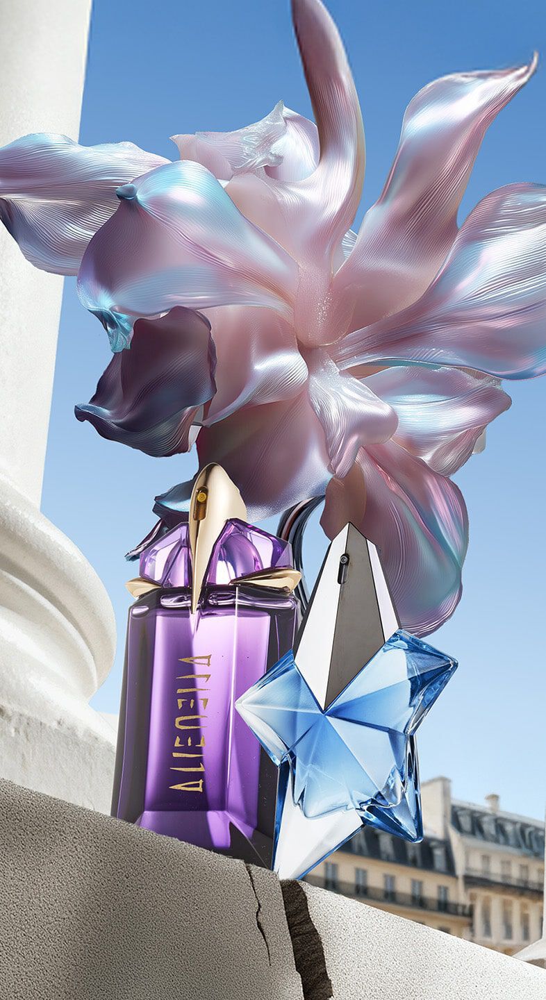 Mugler Mother's Day 2026 campaign banner featuring the iconic Angel and Alien perfume bottles in a celestial floral and Parisian landscape, celebrating extraordinary mothers.