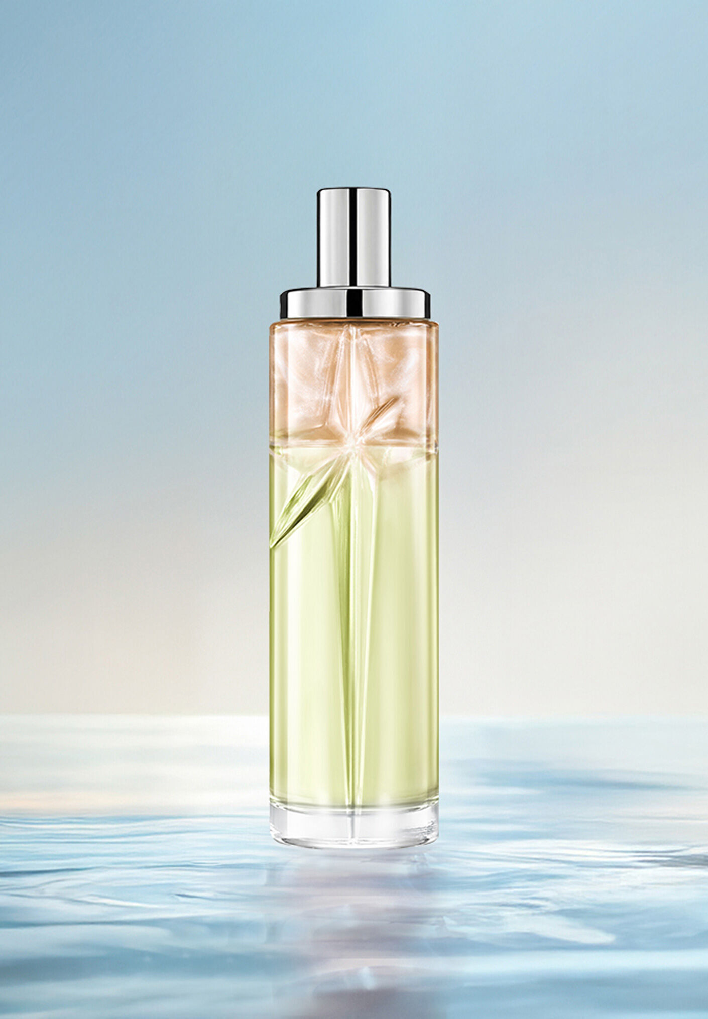 Creamy Delight Starlicious layering recipe: tall bottle with green and amber gradient on water against a soft blue background. Warm, nutty, creamy, slightly sweet scent; 2 sprays Pistachio Praline, 1 Pineapple Musk.