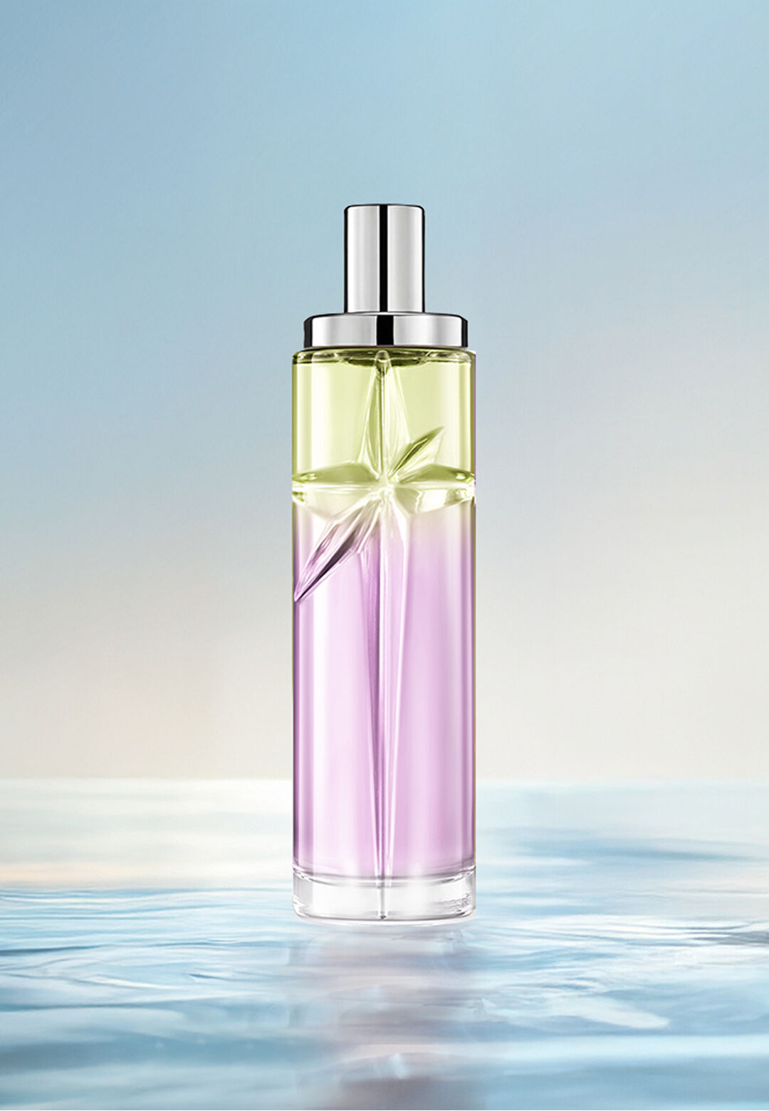 Gourmet Berry Starlicious layering recipe: tall bottle with light green and pink gradient on rippled water against a soft blue background. Tart, sweet, juicy scent with sweet nuttiness; 3 sprays Berry Licorice, 1 Pistachio Praline.