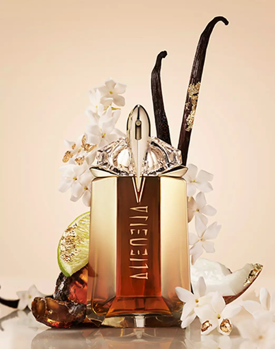 Mugler Alien Goddess Intense Eau De Parfum surrounded by flowers, bergamot, and vanilla beans