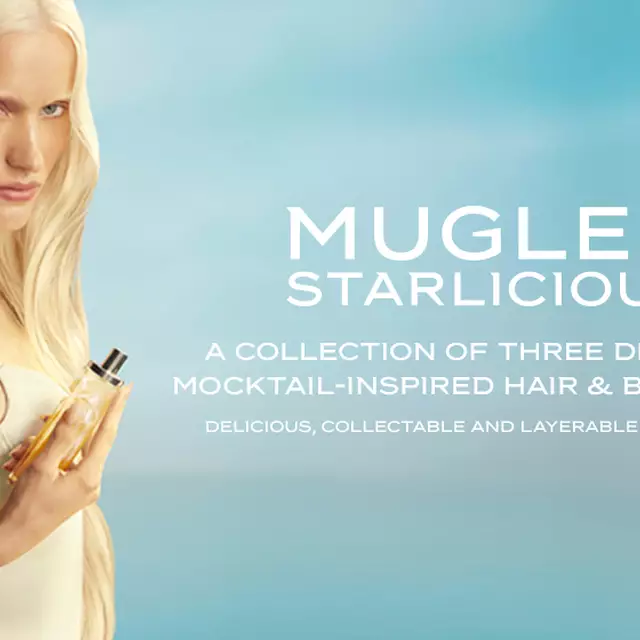 New Mugler Starlicious les eaux gourmandes campaign banner featuring a model with long blonde hair and blue eyes, wearing a pale yellow dress, holding the Pineapple Musk fragrance bottle against a soft blue sky background. The fragrances are delicious, collectable and layerable.